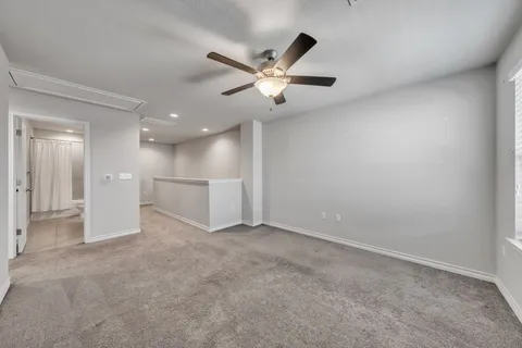 an empty room with a ceiling fan and a ceiling fan