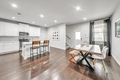 a living room with stainless steel appliances kitchen island granite countertop furniture a dining table and chairs