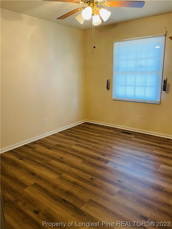 2676 Eldorado Road Fayetteville, NC 28306 - Photo 11 of 19 en empty room with wooden floor and fan