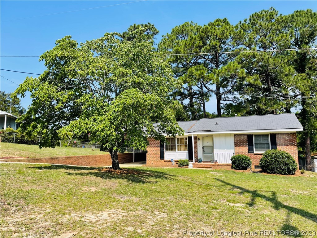 2676 Eldorado Road Fayetteville, NC 28306 - Photo 2 of 19 a front view of a house with a yard