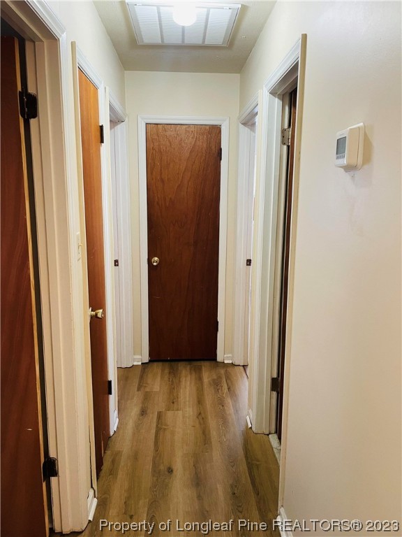 2676 Eldorado Road Fayetteville, NC 28306 - Photo 6 of 19 a view of a hallway with wooden floor and a bathroom