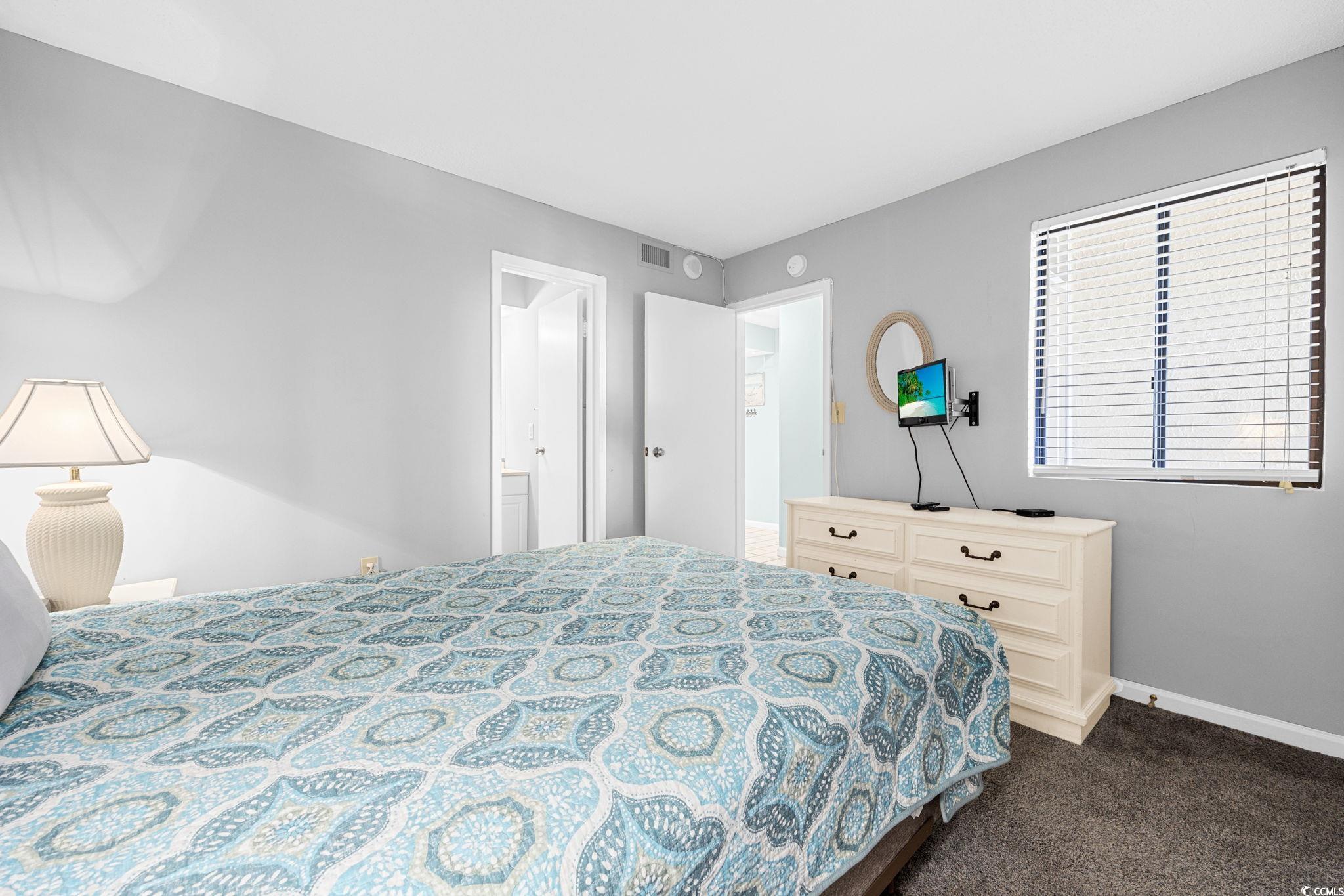4701 South Ocean Boulevard, Unit 2B North Myrtle Beach, SC 29582 - Photo 14 of 31 Bedroom featuring dark colored carpet and baseboards