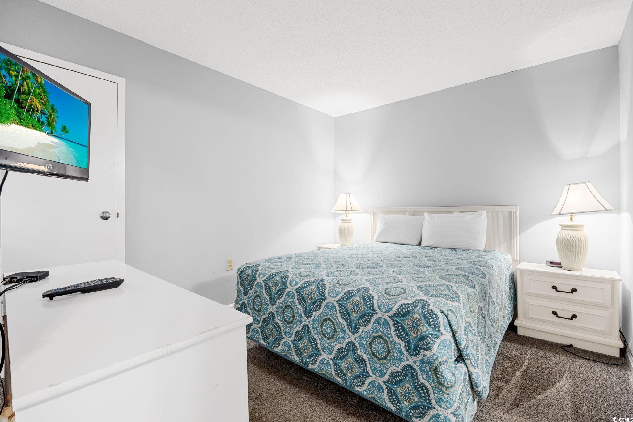 4701 South Ocean Boulevard, Unit 2B North Myrtle Beach, SC 29582 - Photo 15 of 31 Bedroom featuring dark carpet