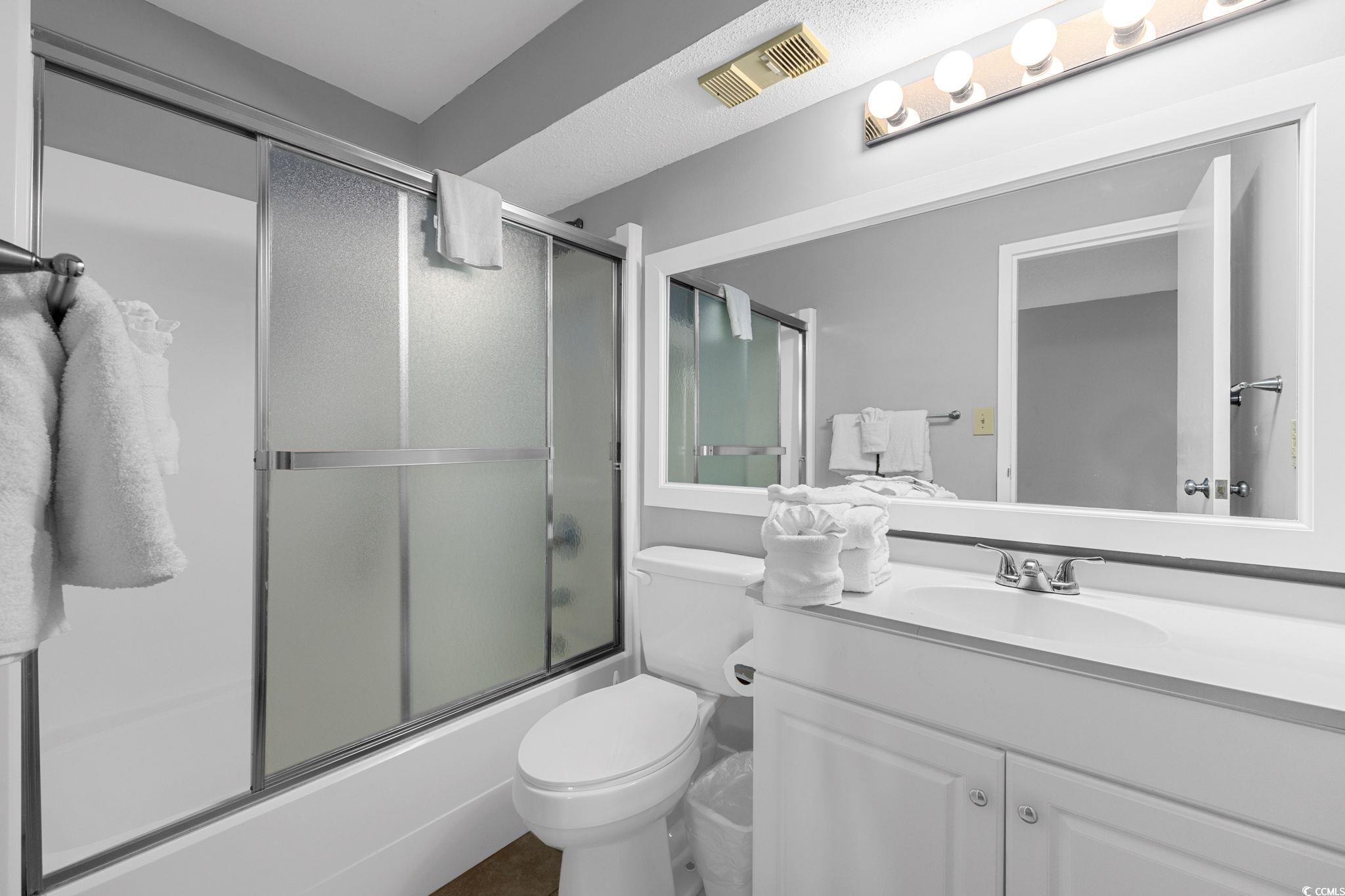 4701 South Ocean Boulevard, Unit 2B North Myrtle Beach, SC 29582 - Photo 16 of 31 Bathroom with combined bath / shower with glass door and vanity
