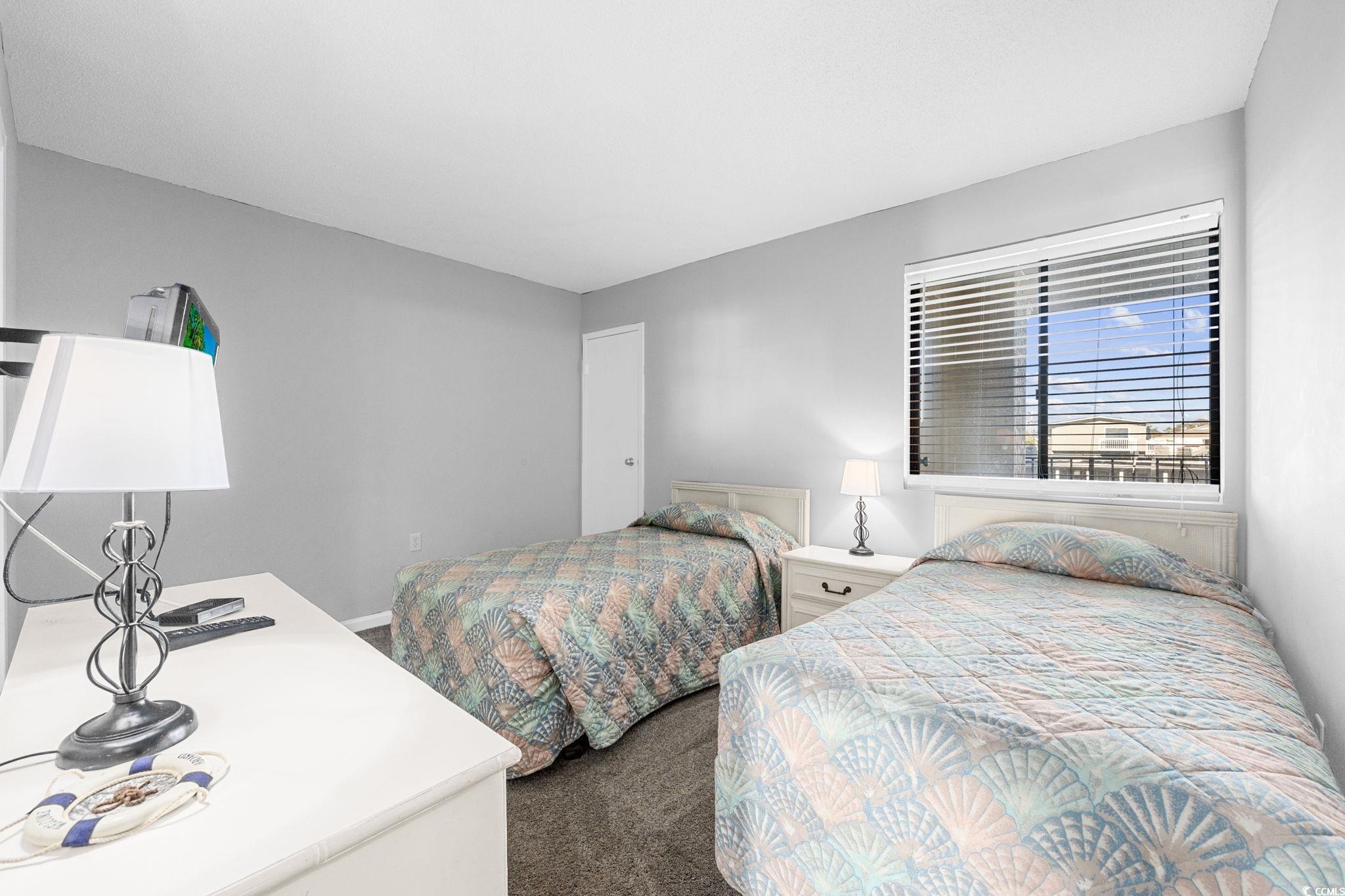 4701 South Ocean Boulevard, Unit 2B North Myrtle Beach, SC 29582 - Photo 22 of 31 Bedroom featuring dark carpet