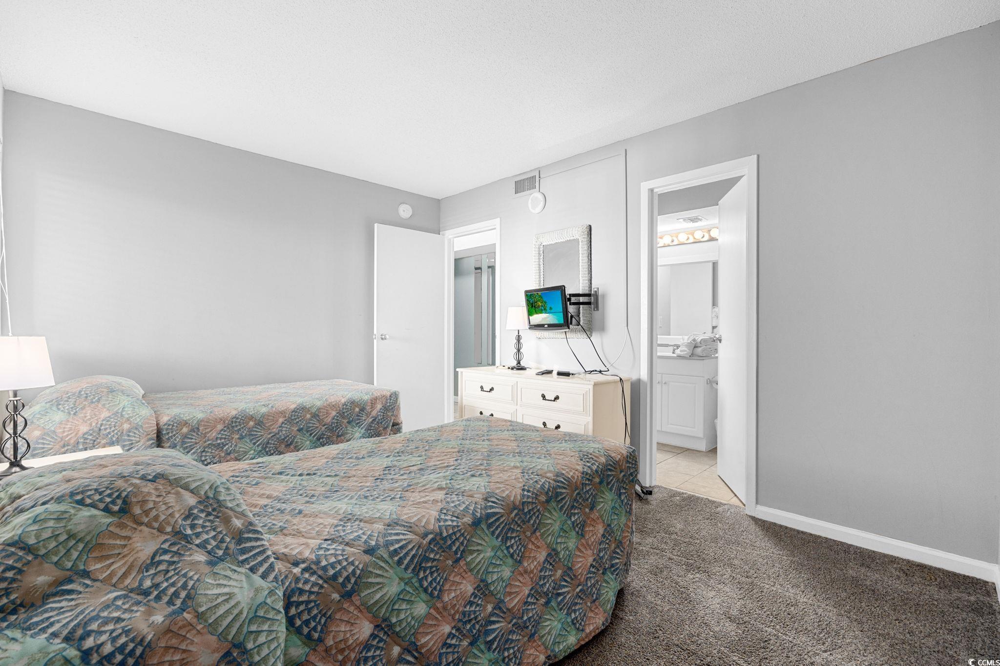 4701 South Ocean Boulevard, Unit 2B North Myrtle Beach, SC 29582 - Photo 23 of 31 Carpeted bedroom with baseboards