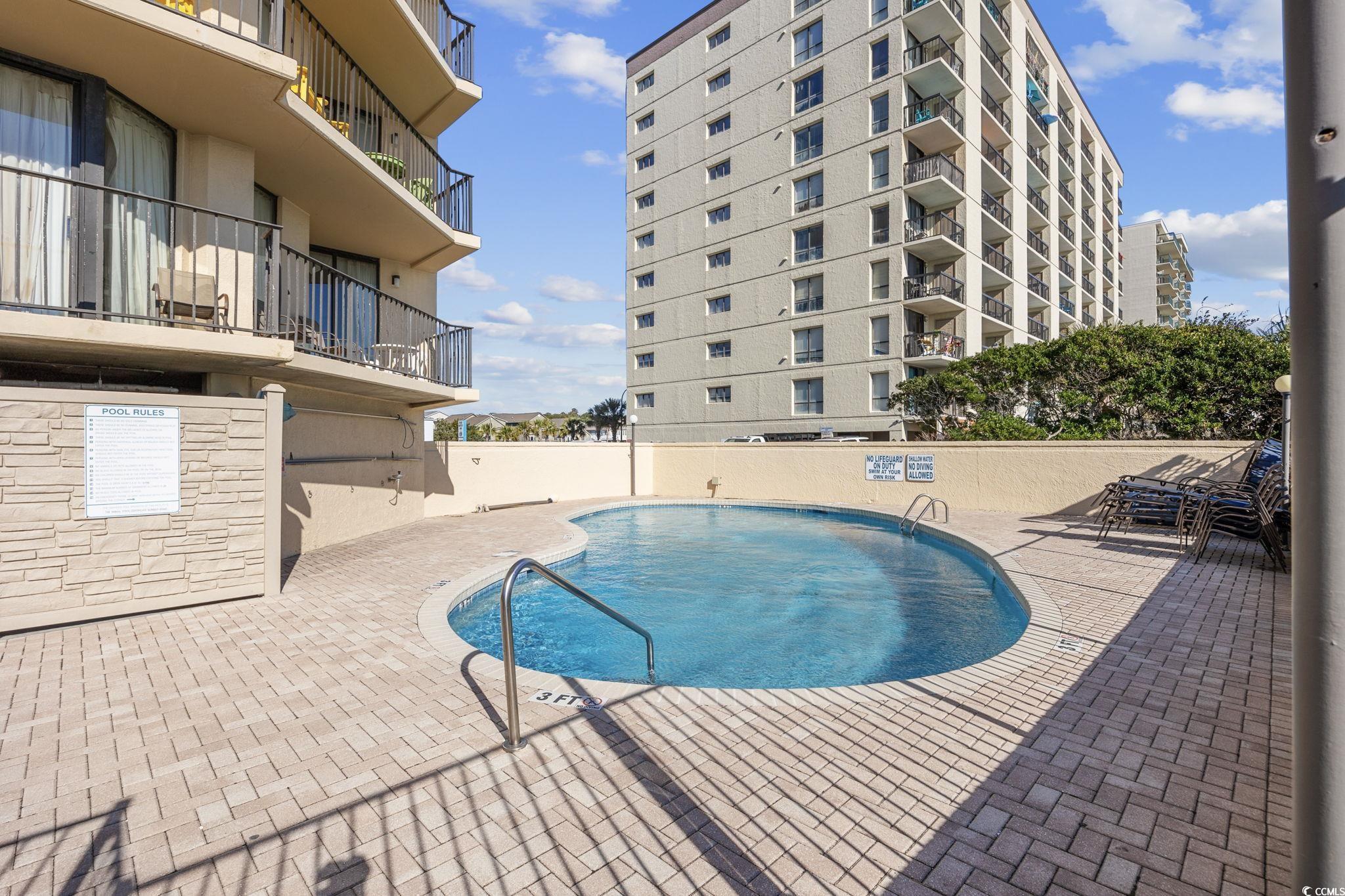 4701 South Ocean Boulevard, Unit 2B North Myrtle Beach, SC 29582 - Photo 29 of 31 Community pool featuring a patio area
