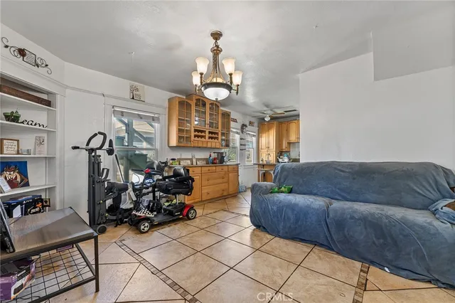a living room with furniture and a chandelier