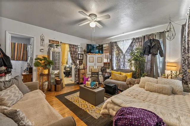 a bedroom with furniture and a large window