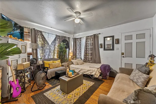 a living room with furniture ceiling fan and a window