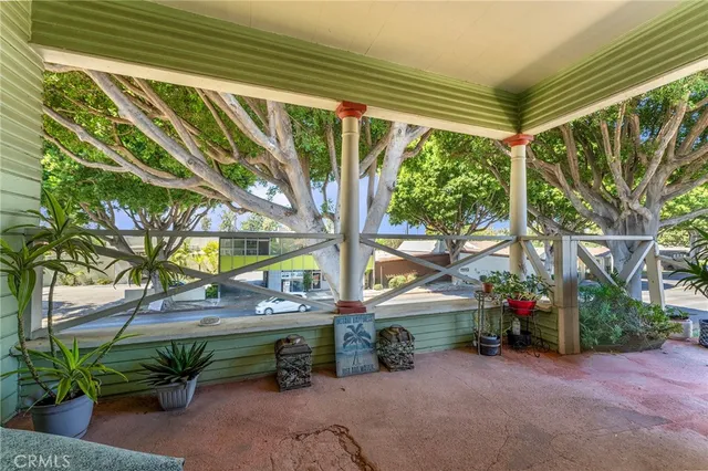 a backyard of a house with barbeque oven table and chairs