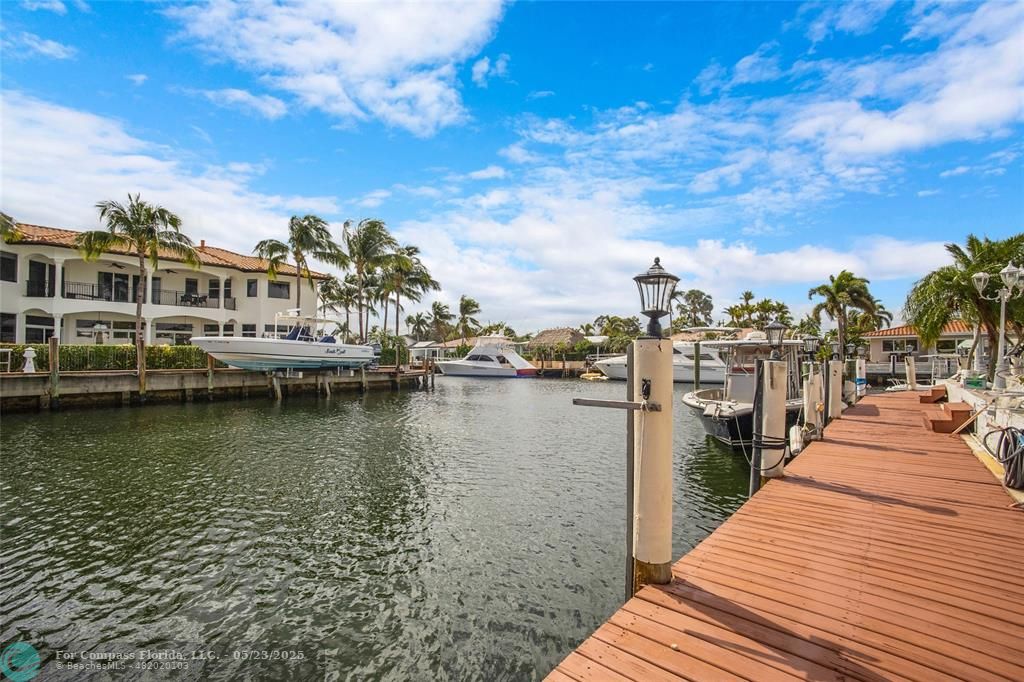 1311 Northeast 27th Way Pompano Beach, FL 33062 - Photo 13 of 58 a view of a lake with boats and trees in the background