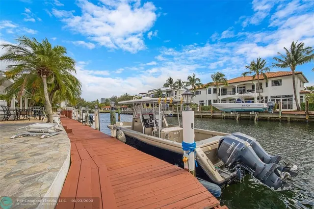 a view of a lake with boats and palm trees