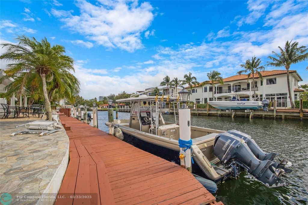 1311 Northeast 27th Way Pompano Beach, FL 33062 - Photo 14 of 58 a view of a lake with boats and palm trees