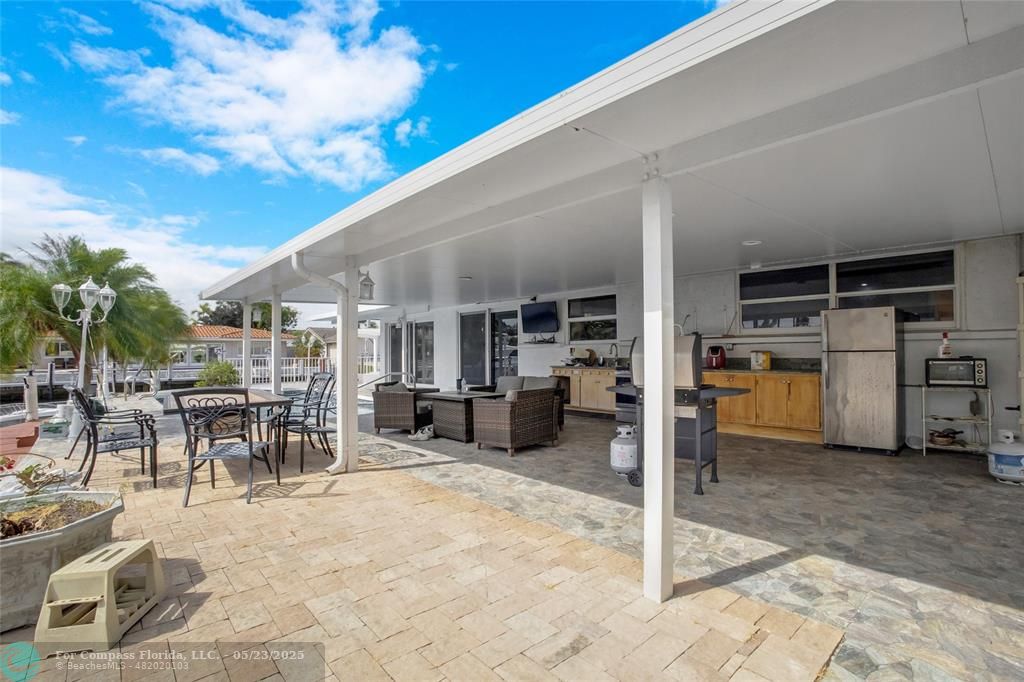 1311 Northeast 27th Way Pompano Beach, FL 33062 - Photo 2 of 58 a view of a patio with table and chairs