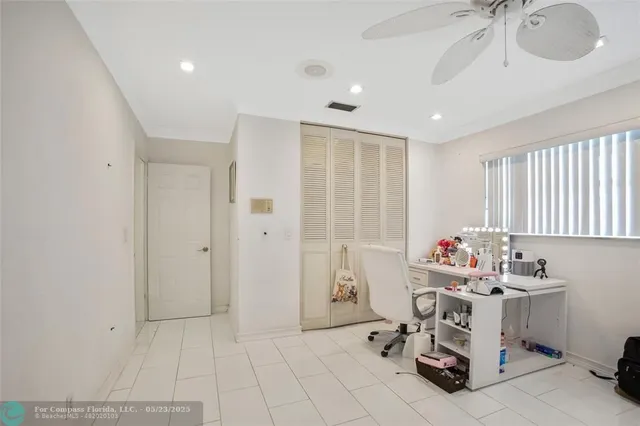 a spacious bedroom with a bed and a ceiling fan