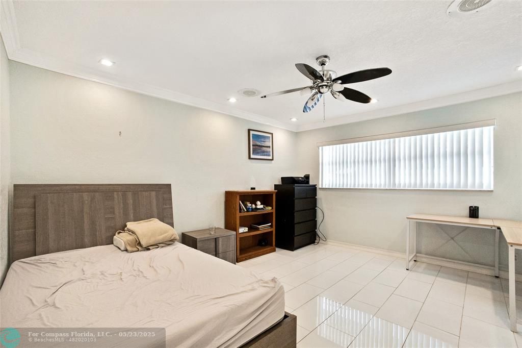 1311 Northeast 27th Way Pompano Beach, FL 33062 - Photo 23 of 58 a bed room with a bed and a chandelier