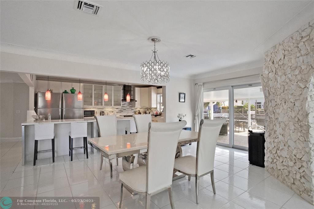 1311 Northeast 27th Way Pompano Beach, FL 33062 - Photo 29 of 58 a view of a dining room with furniture and chandelier