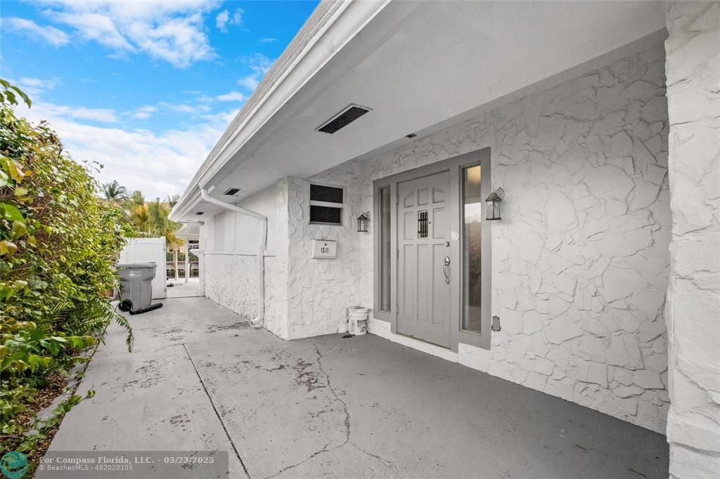 1311 Northeast 27th Way Pompano Beach, FL 33062 - Photo 33 of 58 a view of a house with a backyard