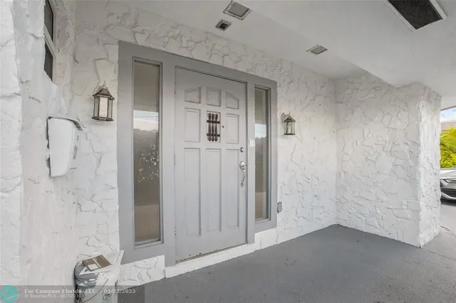 a kitchen with stainless steel appliances granite countertop a sink and a refrigerator