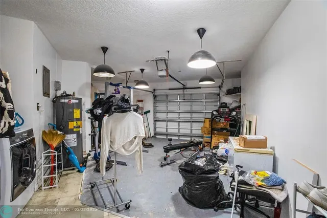 a kitchen with a table chairs refrigerator and microwave
