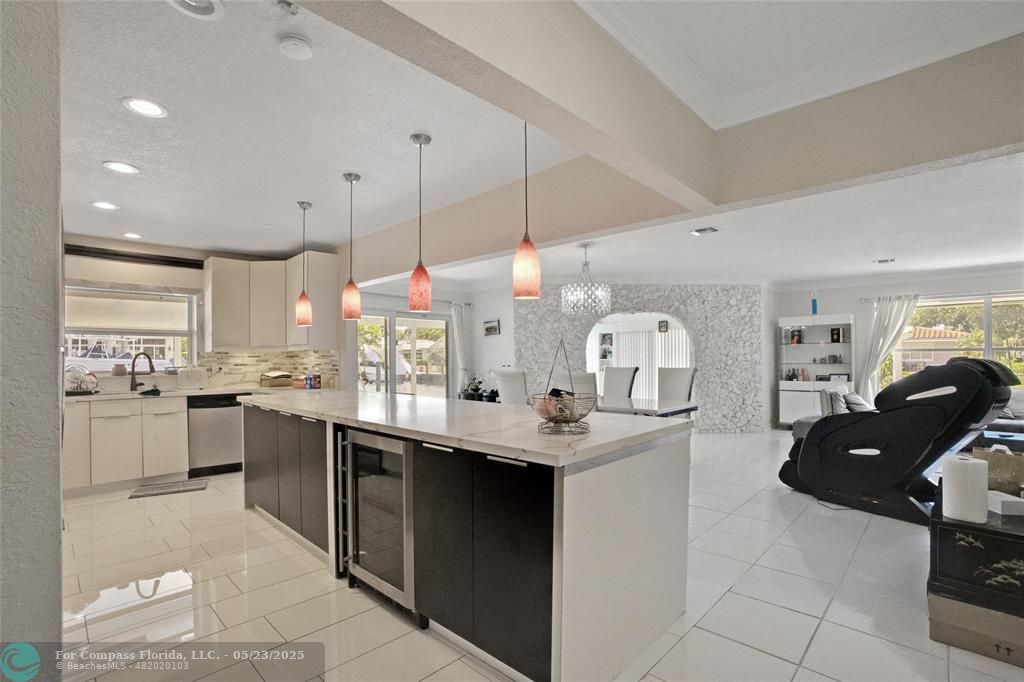 1311 Northeast 27th Way Pompano Beach, FL 33062 - Photo 41 of 58 a kitchen with stainless steel appliances granite countertop a sink and a refrigerator