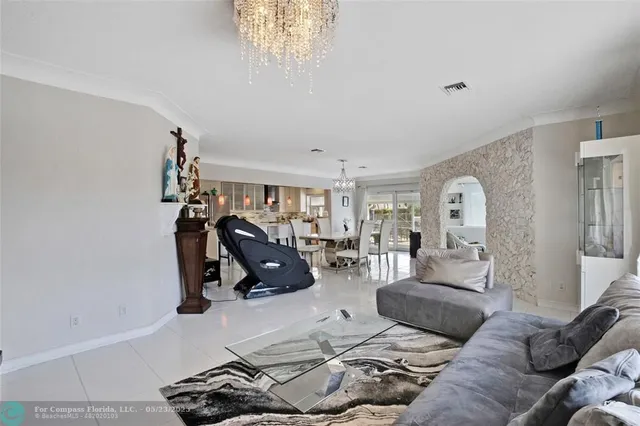 a living room with lots of furniture and a large window