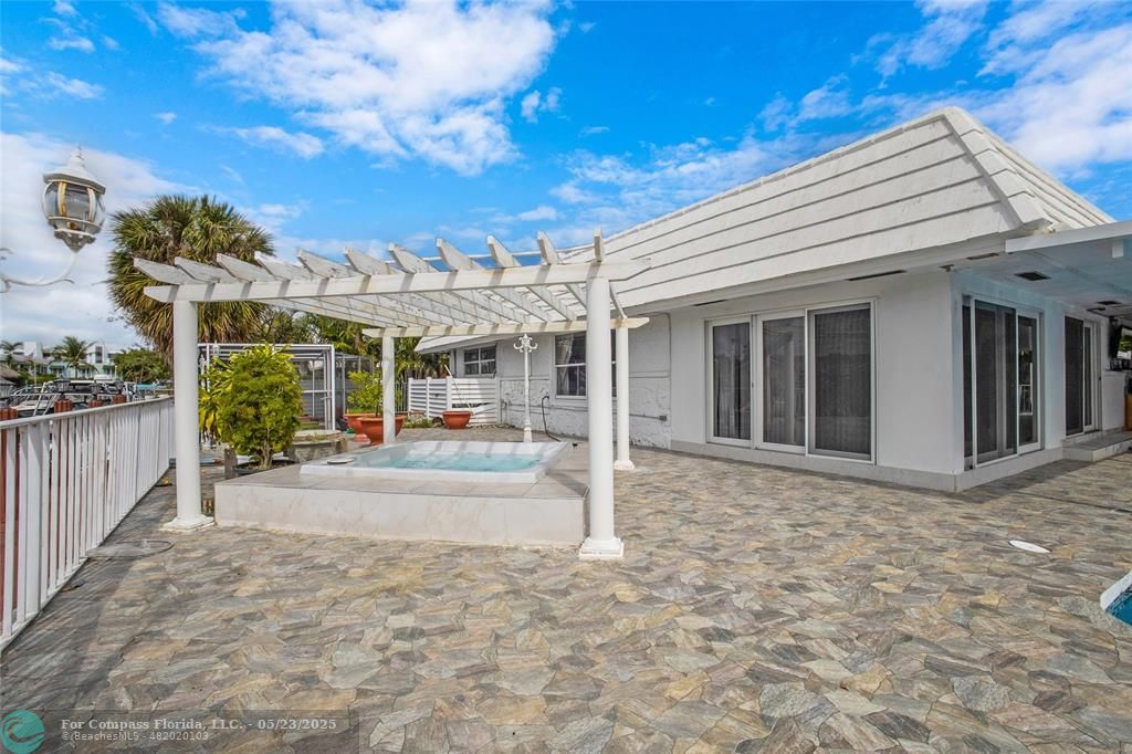 1311 Northeast 27th Way Pompano Beach, FL 33062 - Photo 5 of 58 a view of a house with backyard and porch