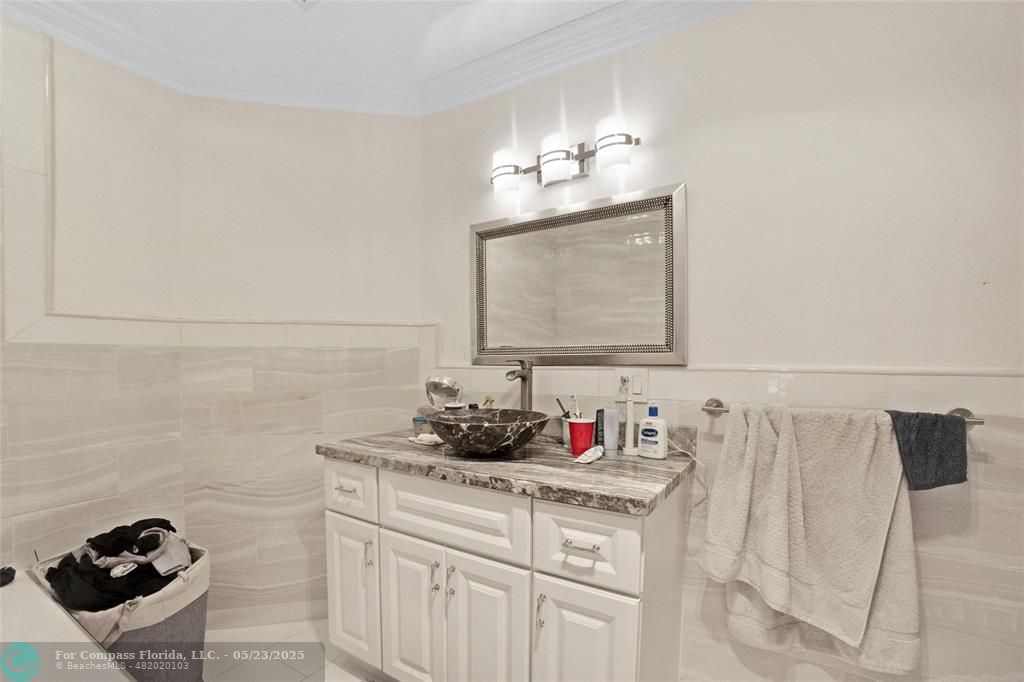 1311 Northeast 27th Way Pompano Beach, FL 33062 - Photo 51 of 58 a bathroom with a sink and a mirror