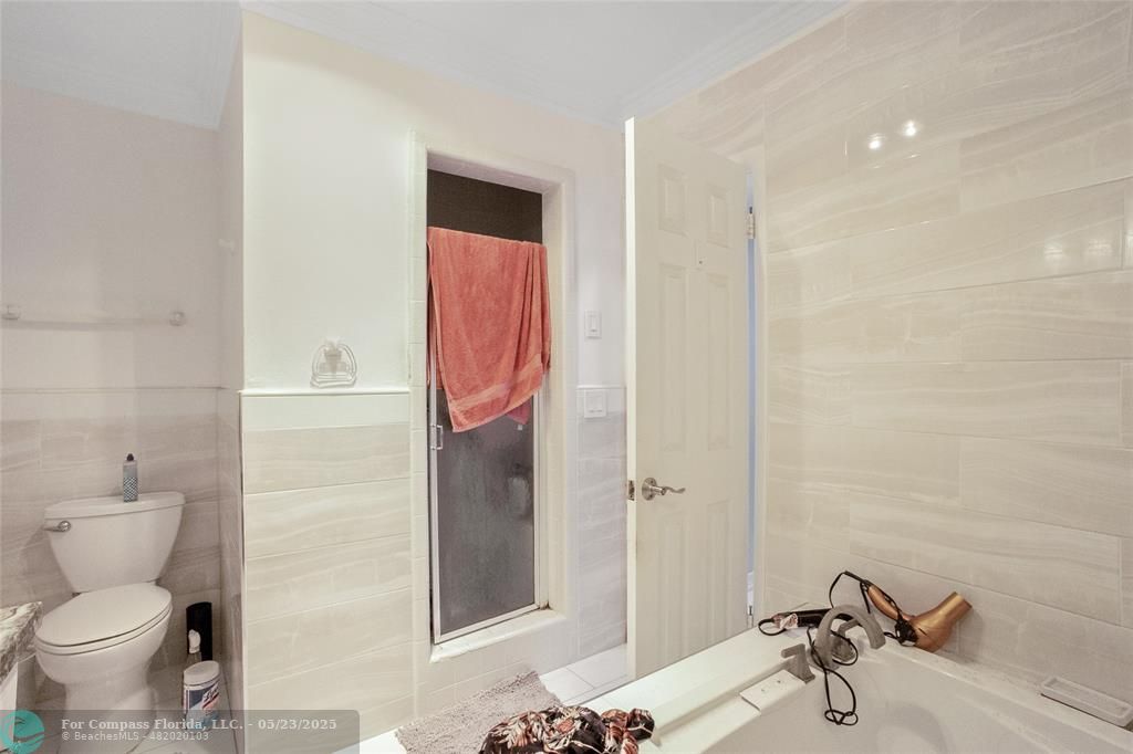 1311 Northeast 27th Way Pompano Beach, FL 33062 - Photo 52 of 58 a bathroom with a shower and a toilet