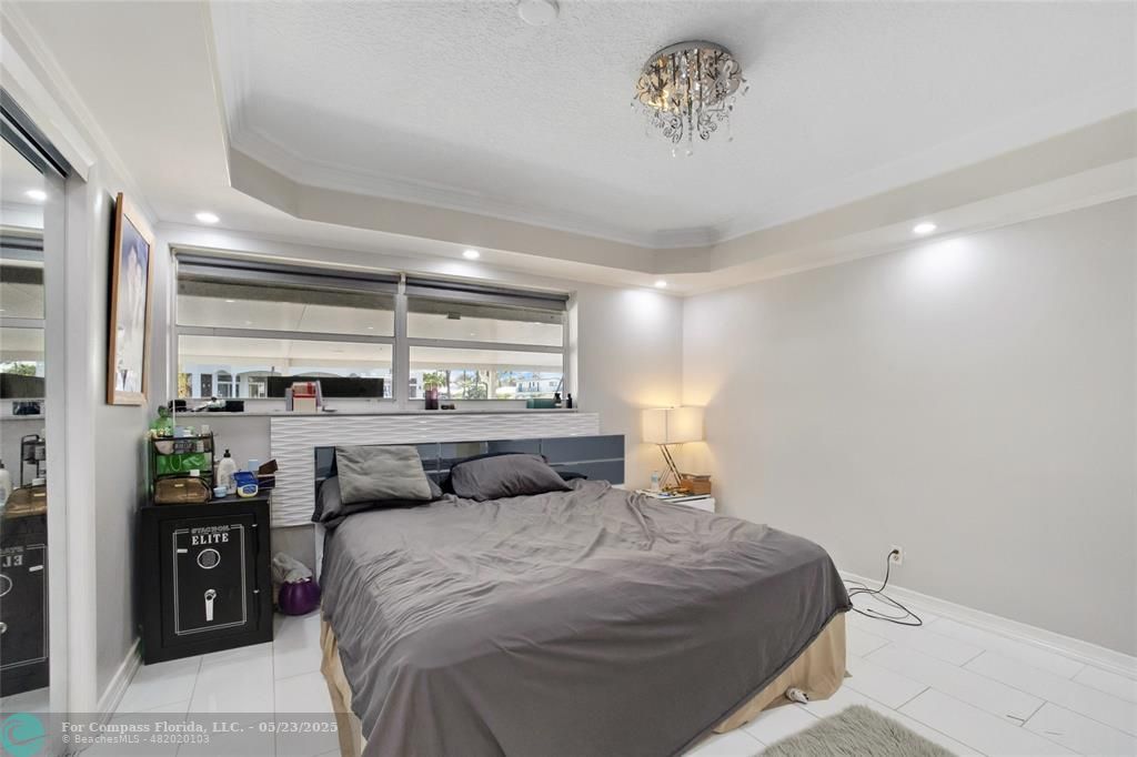 1311 Northeast 27th Way Pompano Beach, FL 33062 - Photo 56 of 58 a bedroom with a bed and window