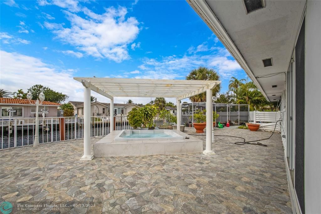 1311 Northeast 27th Way Pompano Beach, FL 33062 - Photo 6 of 58 a view of a porch with a backyard