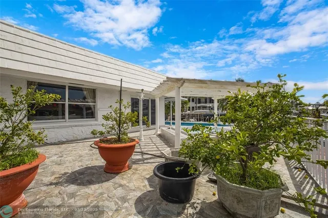 a view of a house with patio and potted plants
