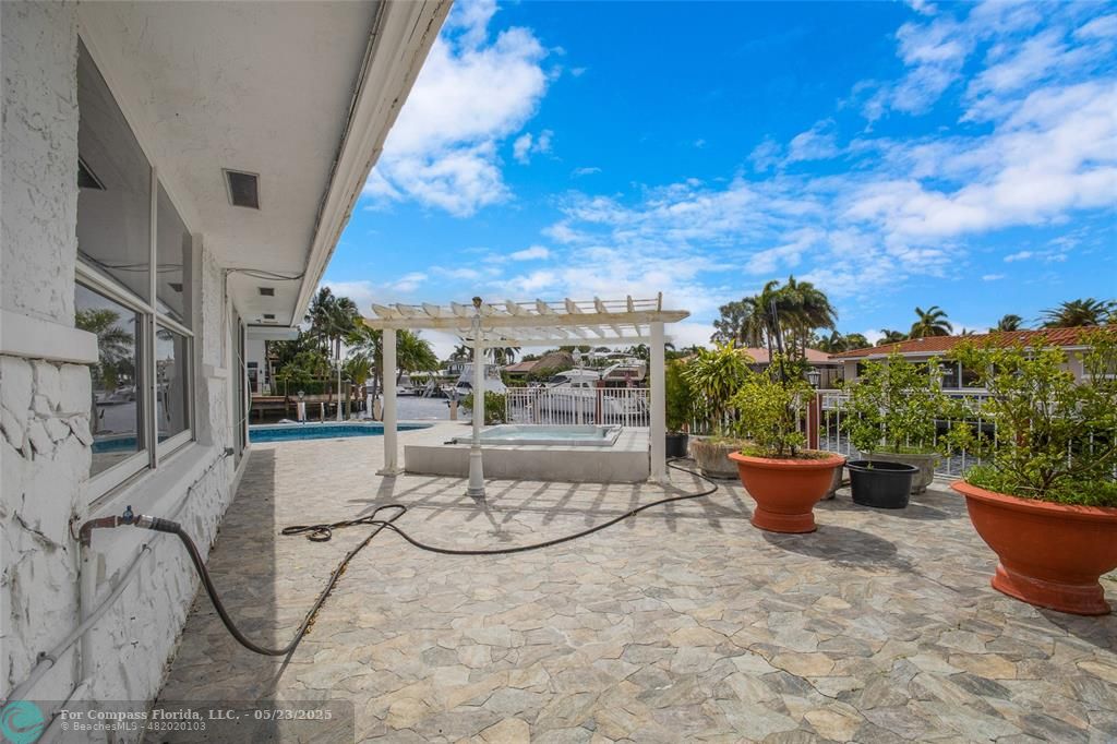1311 Northeast 27th Way Pompano Beach, FL 33062 - Photo 8 of 58 a view of a balcony with chairs and potted plants