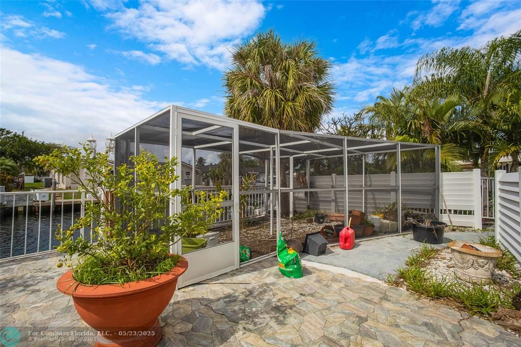 1311 Northeast 27th Way Pompano Beach, FL 33062 - Photo 9 of 58 a view of a backyard with plants and a patio