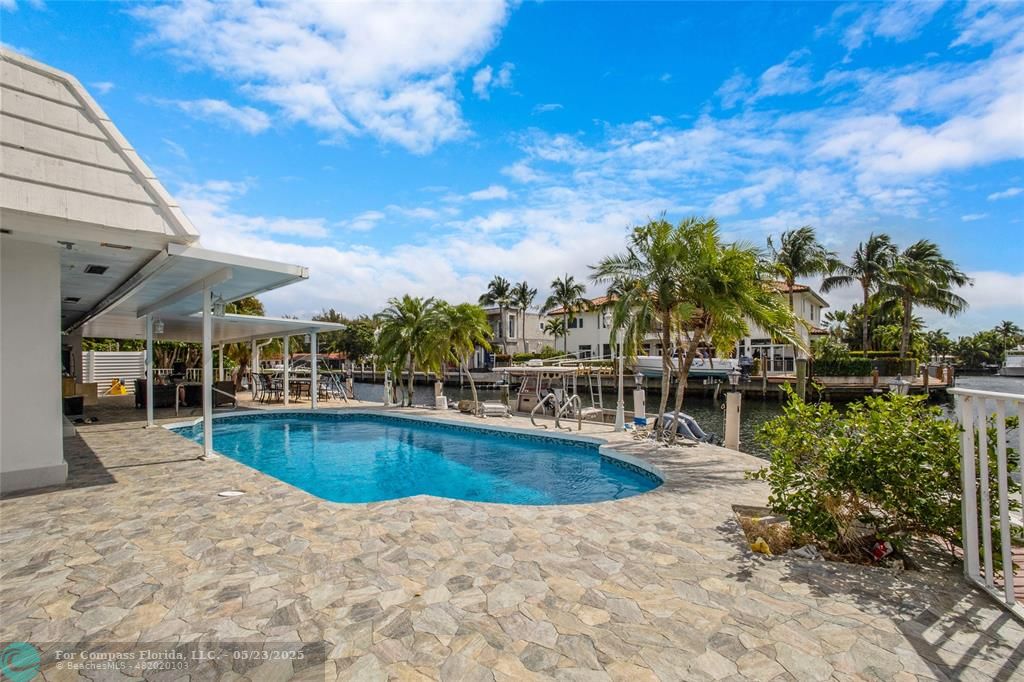 1311 Northeast 27th Way Pompano Beach, FL 33062 - Photo 10 of 58 a view of a swimming pool with a patio