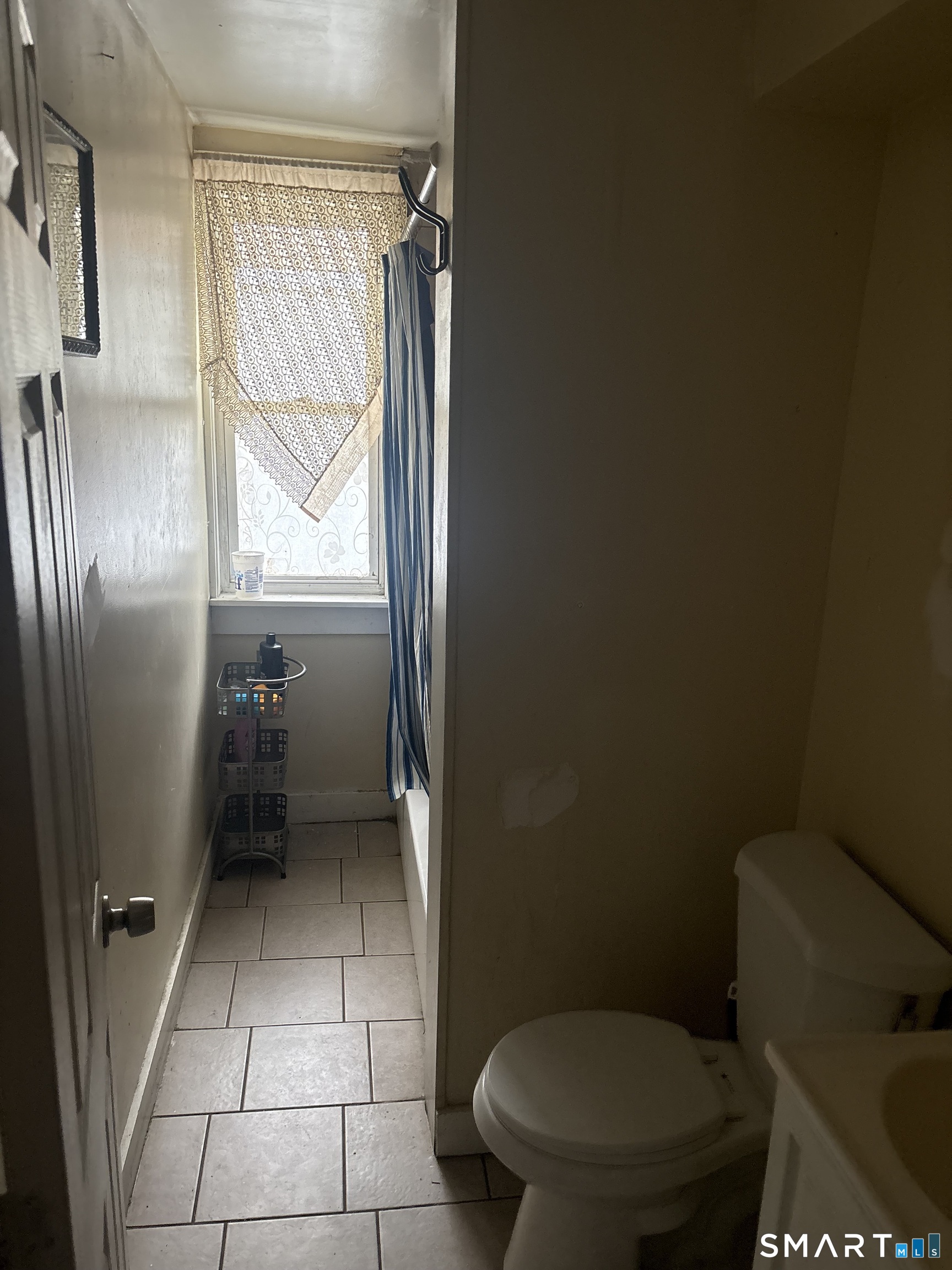 48 Fulton Street New Haven, CT 06513 - Photo 9 of 16 a bathroom with a toilet a window and a shower
