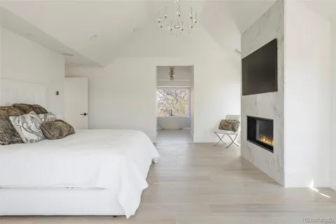 a bedroom with a bed and a fireplace