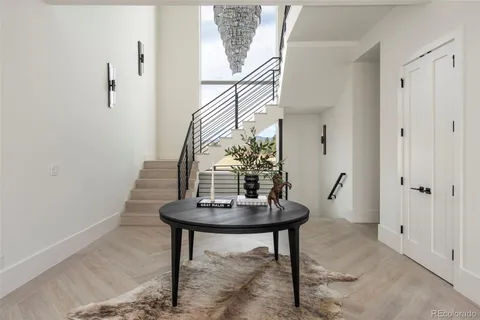 a living room with table and a potted plant