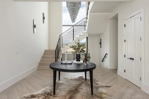 a living room with table and a potted plant