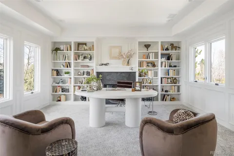 a living room with furniture a rug and a window
