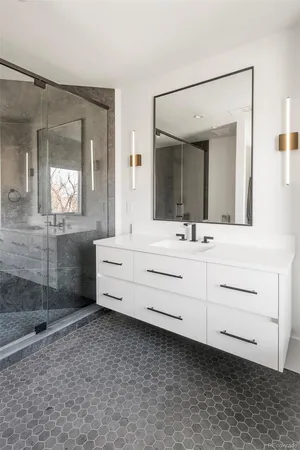 a bathroom with a double vanity sink mirror and shower