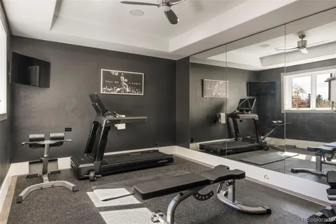 a room with gym equipment and windows