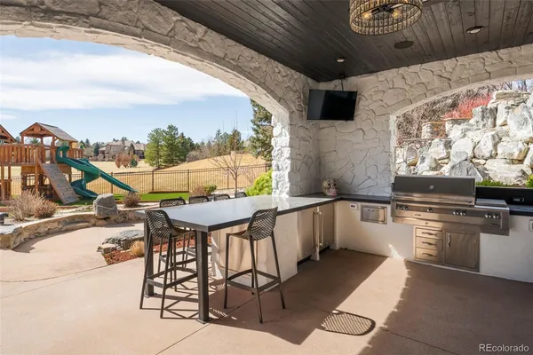 a kitchen with stainless steel appliances kitchen island granite countertop a table and chairs