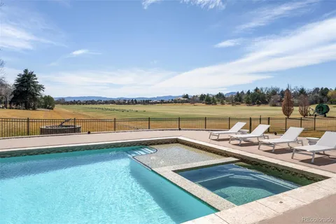 a view of swimming pool with outdoor seating and a garden