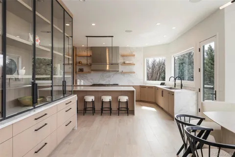 a large kitchen with a table and chairs