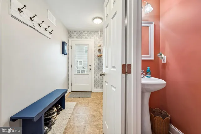 a view of a hallway with bathroom and wooden floor
