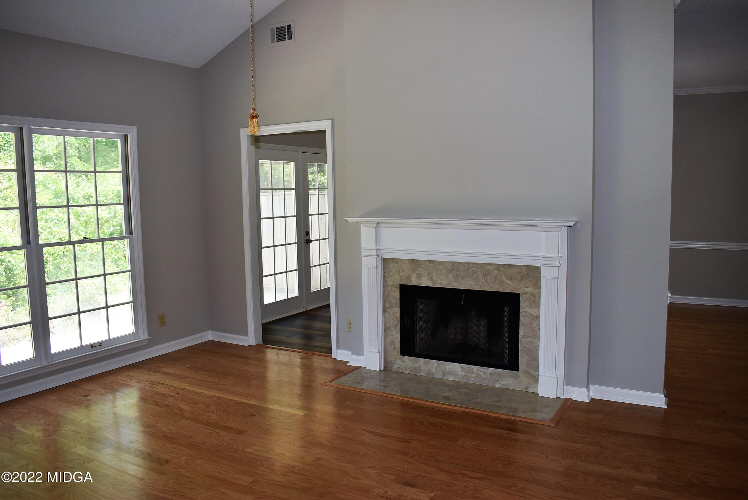 914 Lundy Terrace Macon, GA 31210 - Photo 4 of 15 a view of an empty room with wooden floor and a window