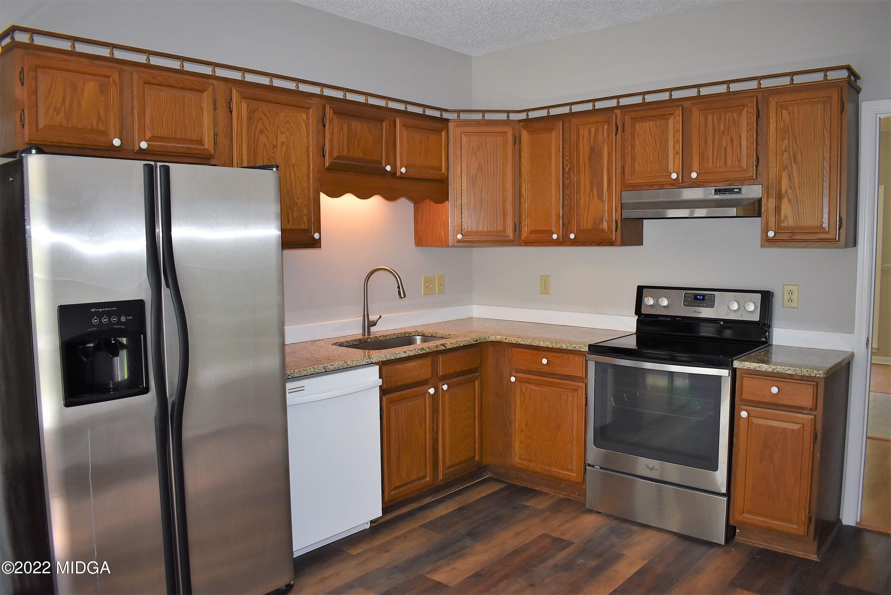 914 Lundy Terrace Macon, GA 31210 - Photo 6 of 15 a kitchen with a refrigerator sink and cabinets