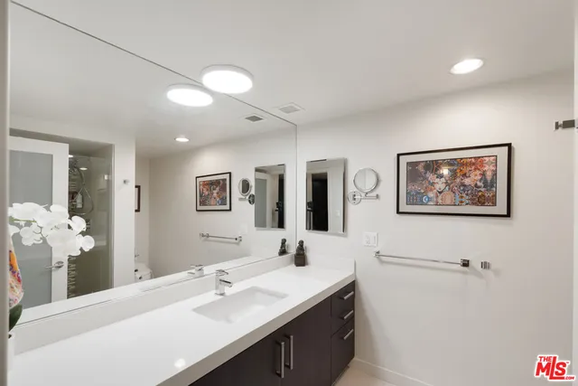 a bathroom with a sink a mirror and a shower